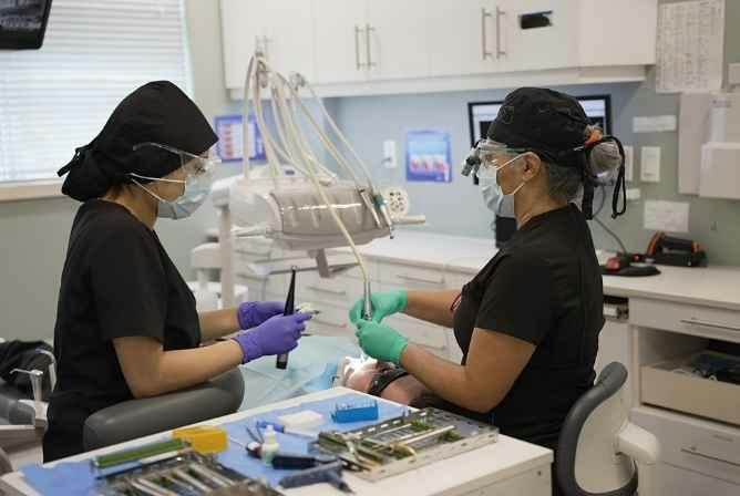 Recent photo of our dentist and assistant at Stonebrook Dental in North York