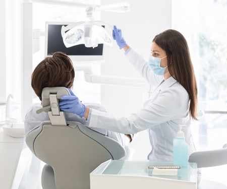 Dentist performing a check-up, emphasizing preventative care