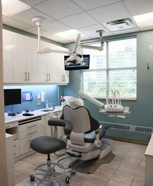 Recent photo of our dentist and assistant consulting with a senior patient at Stonebrook Dental in North York