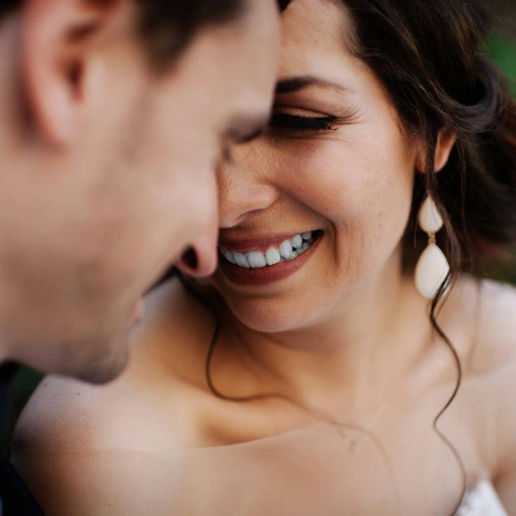 Couple sharing a special moment on their wedding day, smiles ready for photos